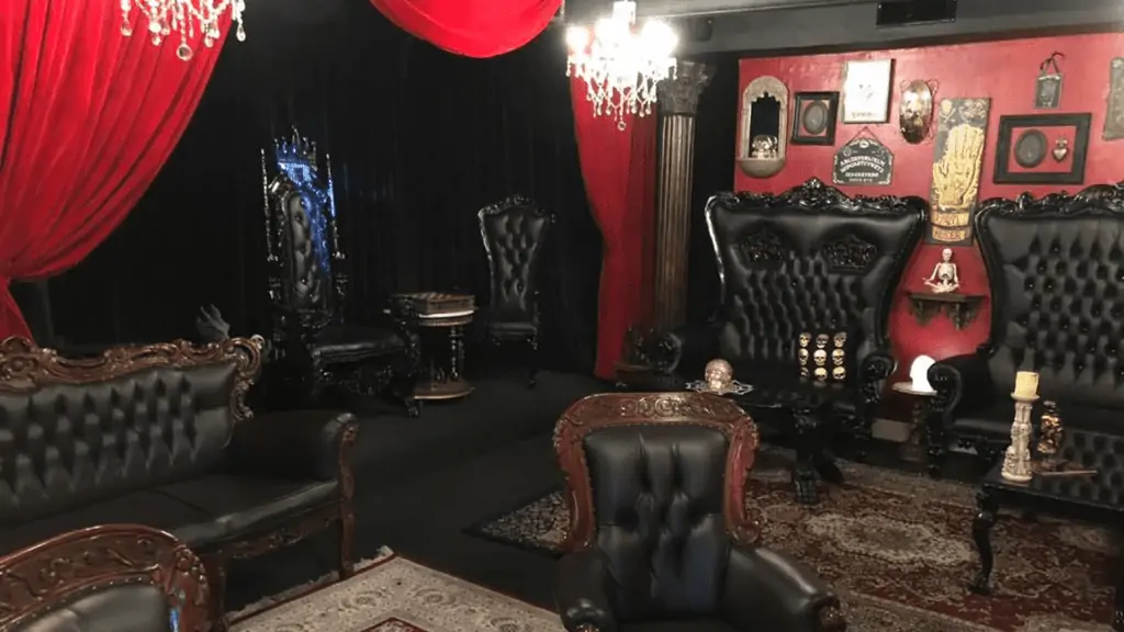 Interior of a lounge with gothic decor and red velvet curtains