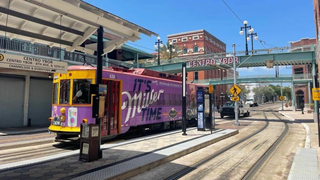 exterior of a large streetcar in a downtown area