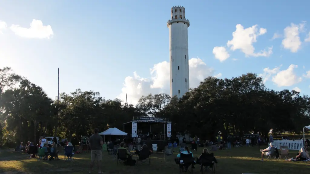 a alrge tower in the background of an outdoor music festival