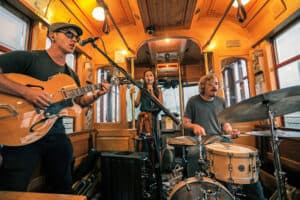 Band playing on street car