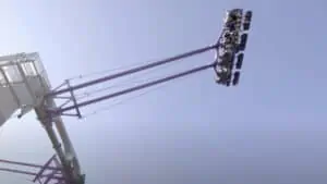 a giant swing soars 135 feet in the air with two rows of riders featured.