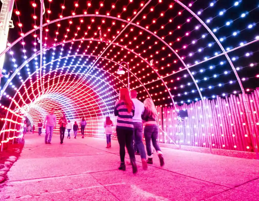Guests walk beneath a huge lighted Christmas tunnel. 