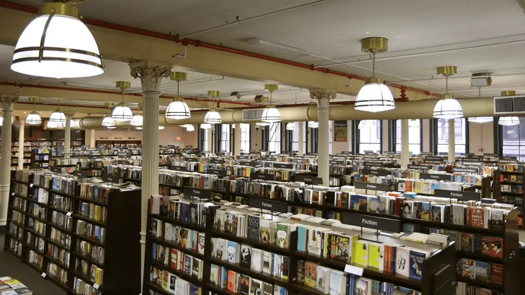 inside a bookstore. Rows of giant bookshelves are spread out inside.