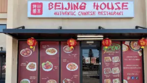 exterior of a Chinese restaurant with a red and white sign above the door.