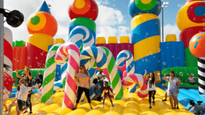 A large bounce castle with inflatable candy canes and inflatable castle structures set up.