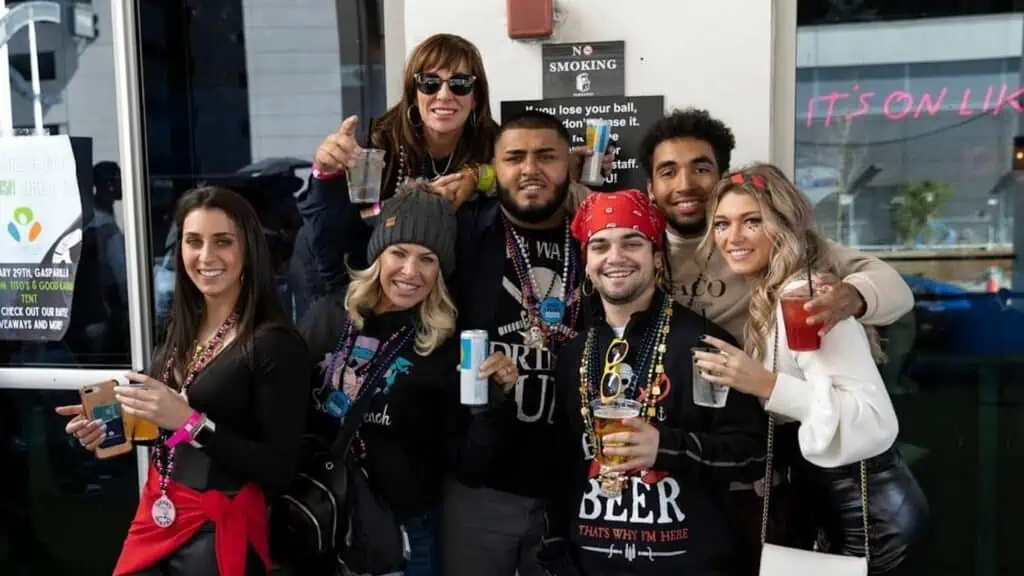 A group of people in pirate costumes gathered in front of bar.