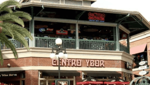 Exterior of a second-floor bar with a giant red Centro Ybor sign on the front.