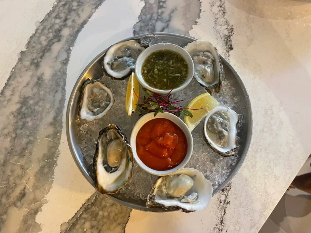 a plate of oysters on a marble countertop
