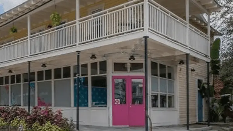 Exterior of old building in Ybor City with a pink front door.