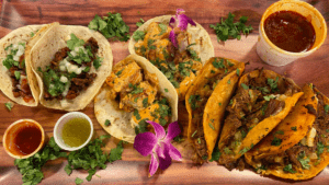 aerial photo of a plate of tacos with an array of sauces and stews next to the dishes