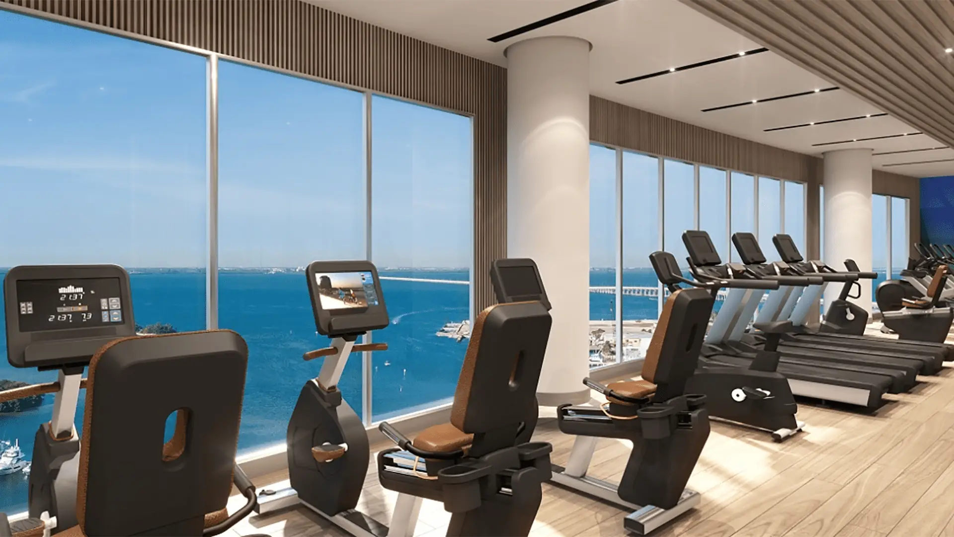 rendering of a top floor gym with rows of cardio machines set along the windows.