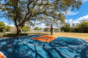 A basketball court with an orange and blue paint job.