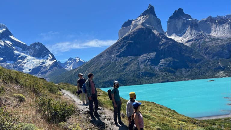 Stunning view of Torres del Paine with hikers looking at Los Cuernos or The Horns