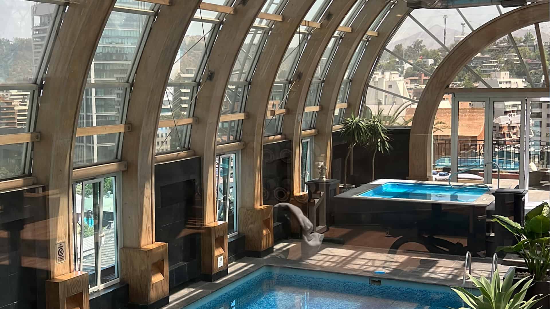 Rooftop pool and hot tub with arched glass ceiling
