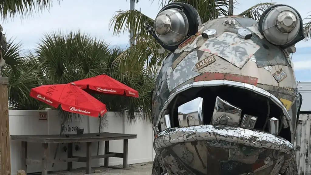 Large metal outdoor sculpture of a giant grouper