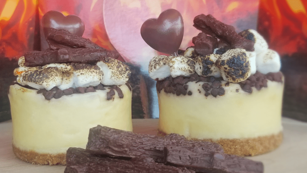 two pieces of cake topped with dark chocolate whipped cream and heart shaped chocolates.