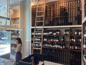 Inside a large wine shop with rows of bottles displayed on the shelves