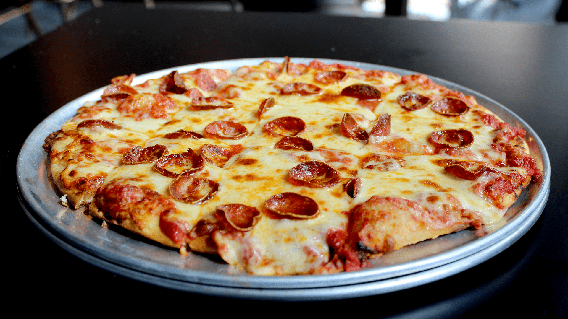 A melty pepperoni pizza on a plate