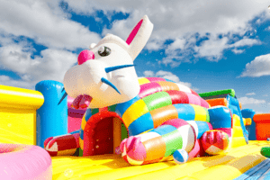 Inflatable rabbit inside of a large bounce house.