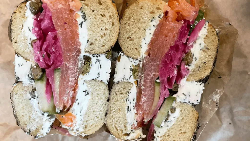 Aerial of a bagel sandwich loaded with lox. 