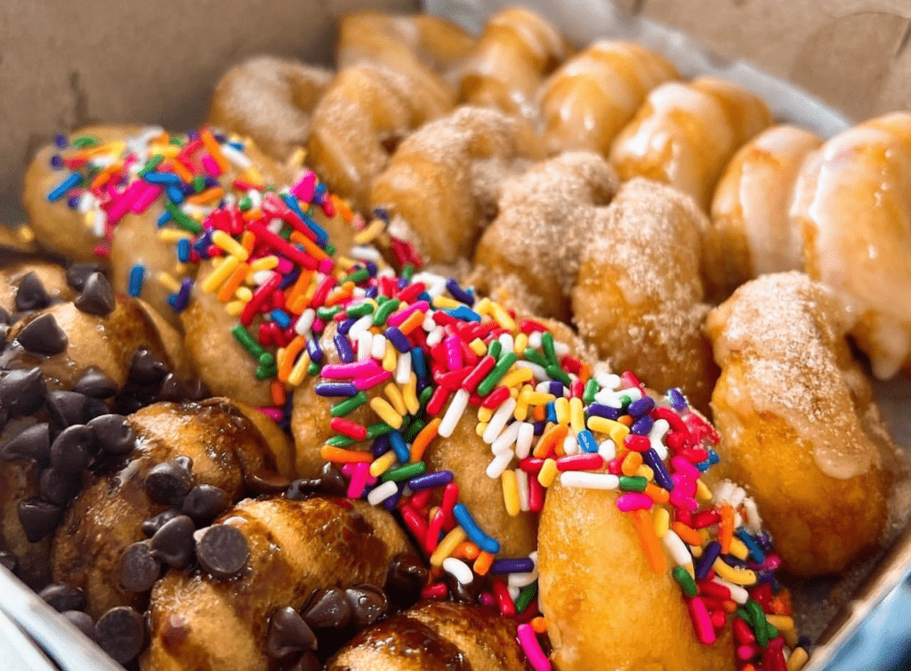 Multiple frosting covered mini donuts. 