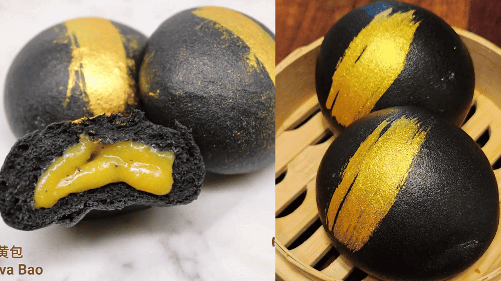bao buns the color of black and gold arranged on a plate 