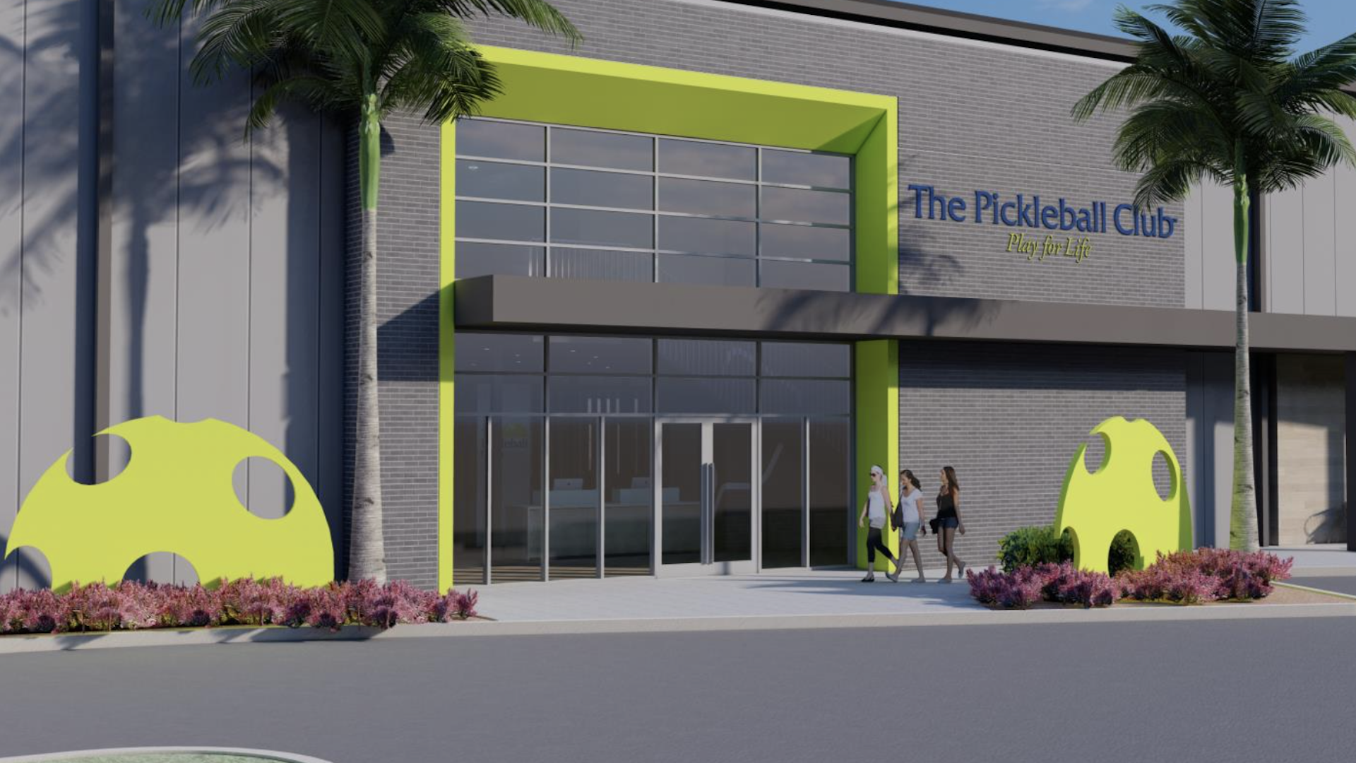 rendering of a pickleball facility. The exterior is silver with bright yellow pickle balls painted on the ground level.