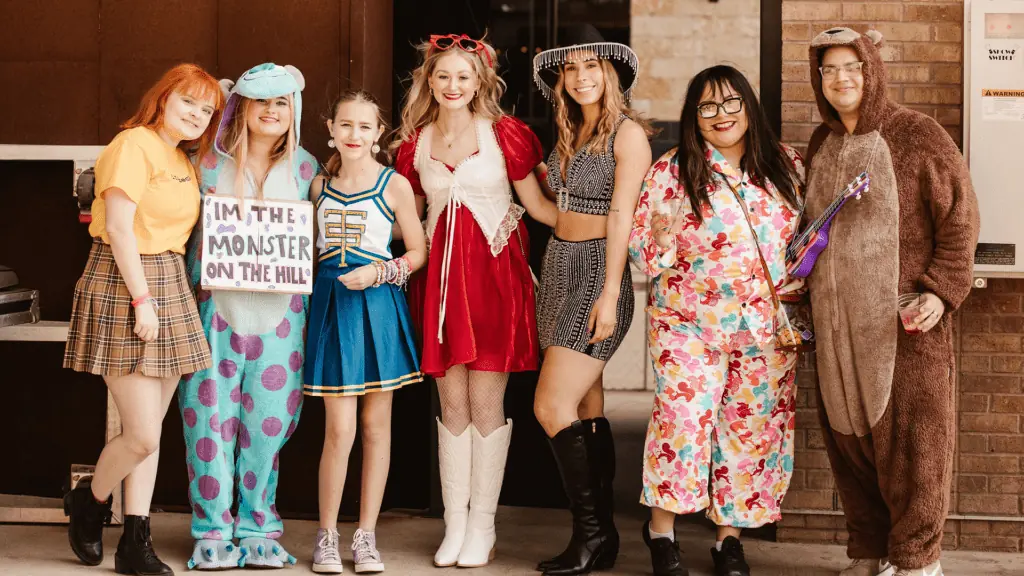 a group of people dressed up in. Taylor Swift inspired costumes. 