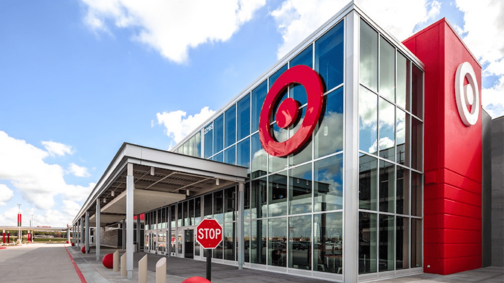 exterior of a large red and white Target store. A large glass atrium is at the entrance.