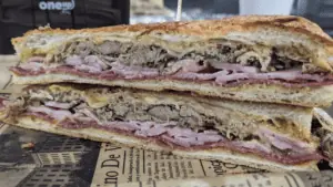 Cuban sandwich loaded with pork and ham on a plate