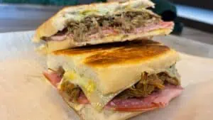 Two halves of a Cuban sandwich stacked on top of one another