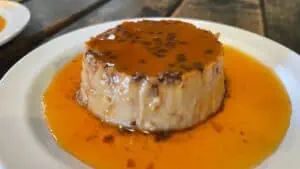 Flan on a plate with sauce on top