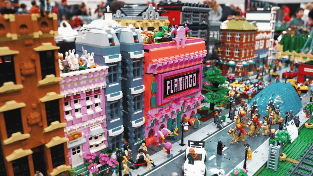 a LEGO city display with tall buildings and roads constructed from small bricks