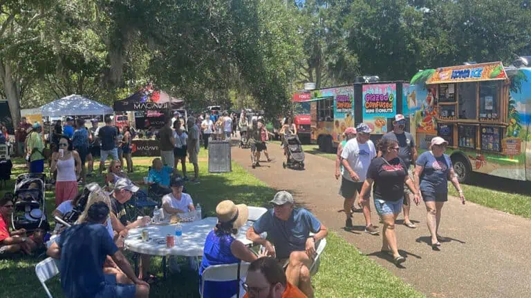 food trucks are set up a at public park for a festival