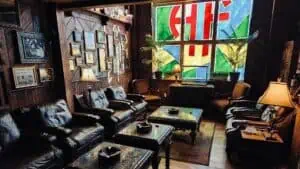 Interior of a cigar lounge with a stained glass window in the corner