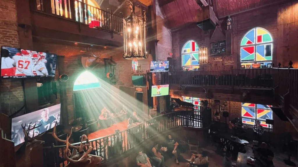 church with stained glass windows. A light shines through on the bar below