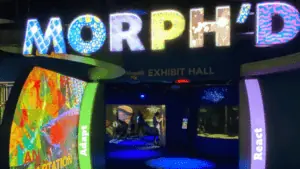 entrance way inside an aquarium with an illuminated sign that reads "MORPH'D"