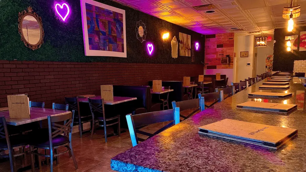 interior of a wine bar with neon hears on the floral wall