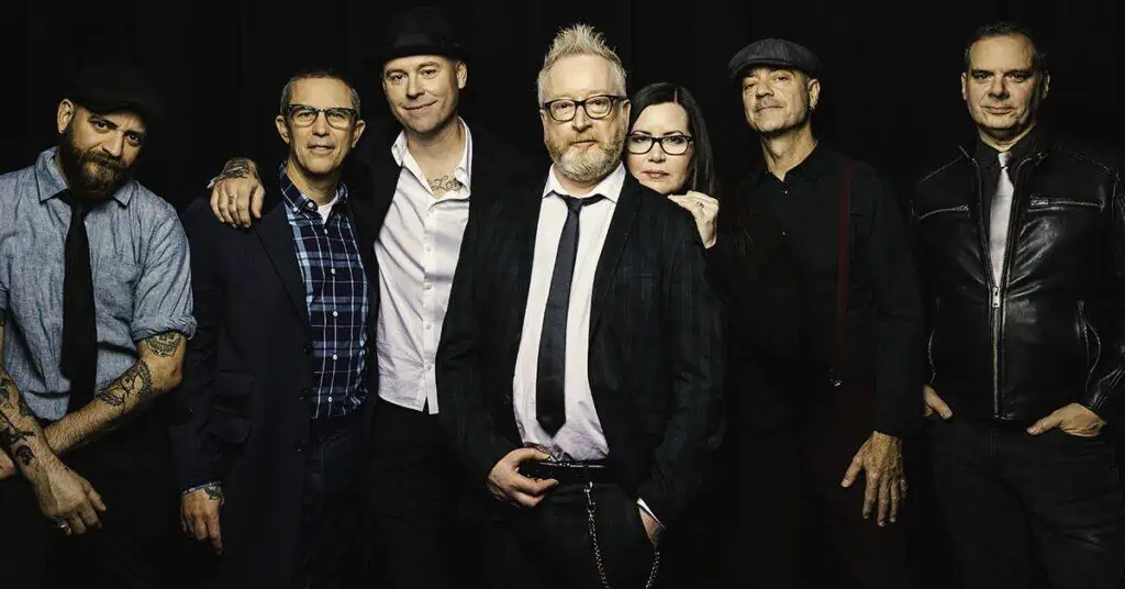the band flogging molly poses in front of a black background