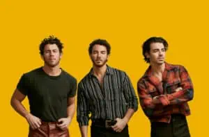 the Jonas Brothers on a yellow background