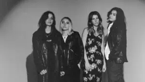 The Aces band poses together in black and white