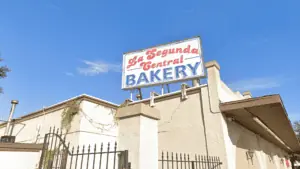 exterior of a bakery with a white and red sign on the top
