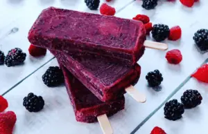 Three purple pops surrounded by berries