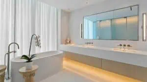 a luxurious bathroom with a bath tub and multiple sinks.