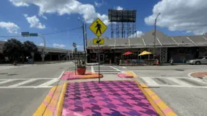 street murals painted by crosswalks leading to a small cafe