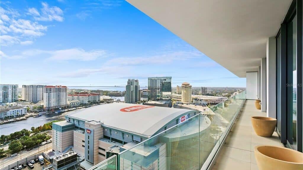 balcony view of a downtown area. A big stadium is visible.