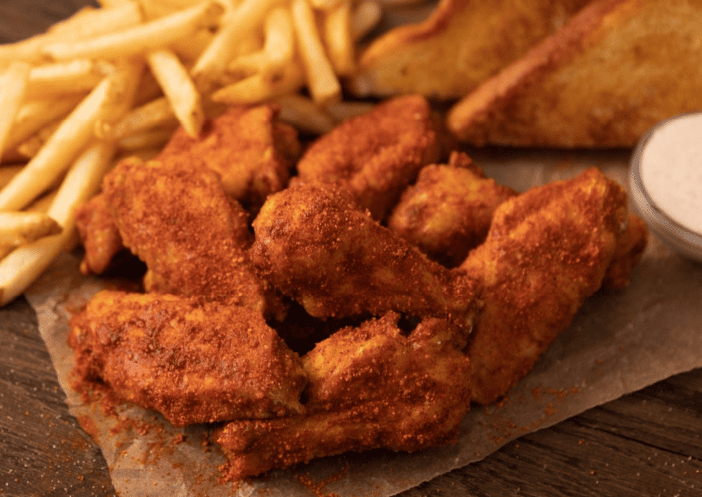 plate of breaded chicken tenders with golden fries