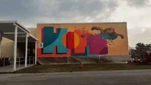 mural on the outside of a school that reads "hope" in rainbow colors.