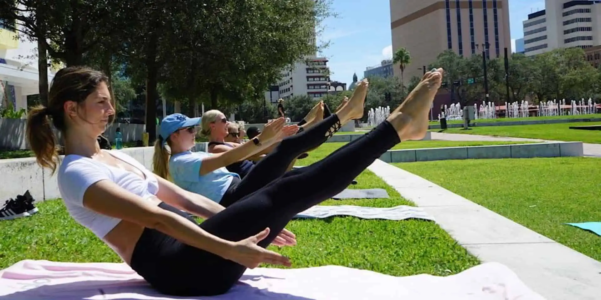 women in the park doing pilates