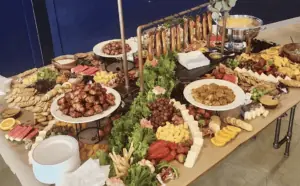 A spread of cheese, meats, and pretzels on a table